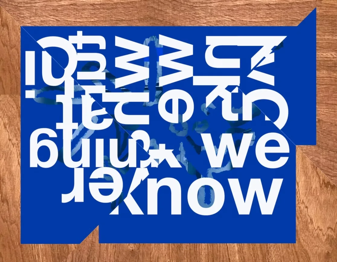 Blue and white typographic artwork on a wooden surface