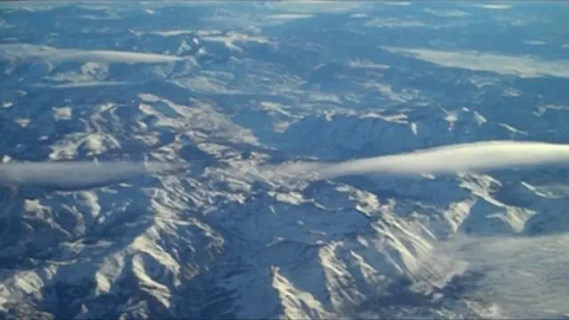 Mountain ranges and clouds seen from above; still from The Quiet Life